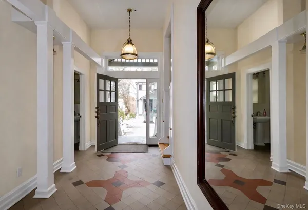 a view of a hallway with wooden floor and a livingroom