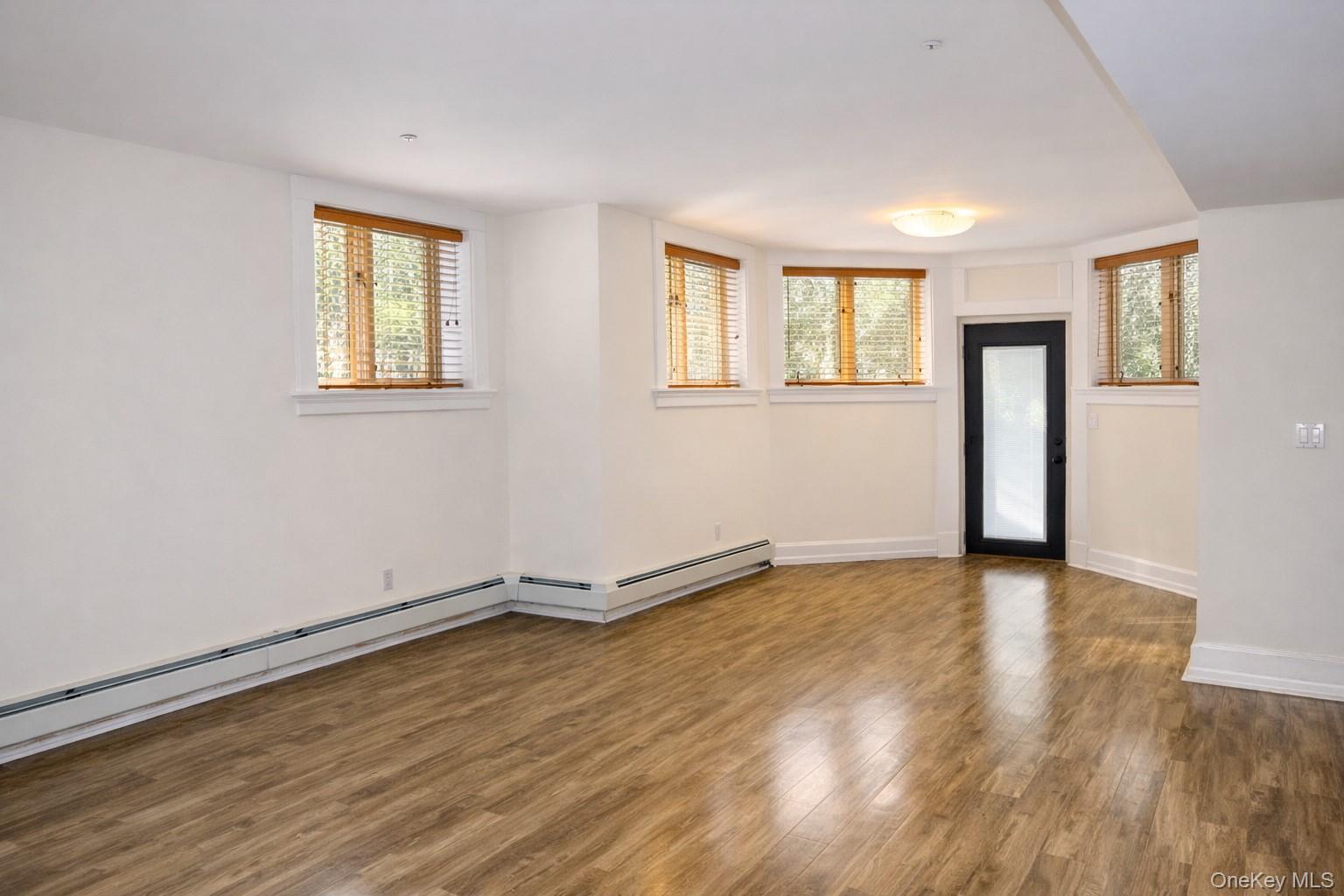 16 Clinton Avenue Dobbs Ferry, NY 10522 - Photo 24 of 26 a view of an empty room with wooden floor and a window