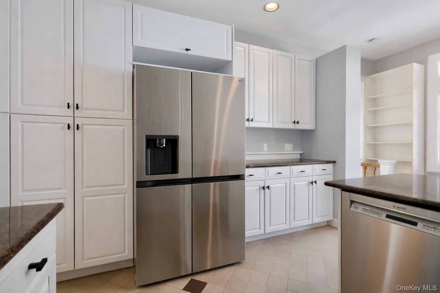 16 Clinton Avenue Dobbs Ferry, NY 10522 - Photo 7 of 26 a kitchen with granite countertop stainless steel appliances a refrigerator a sink and cabinets