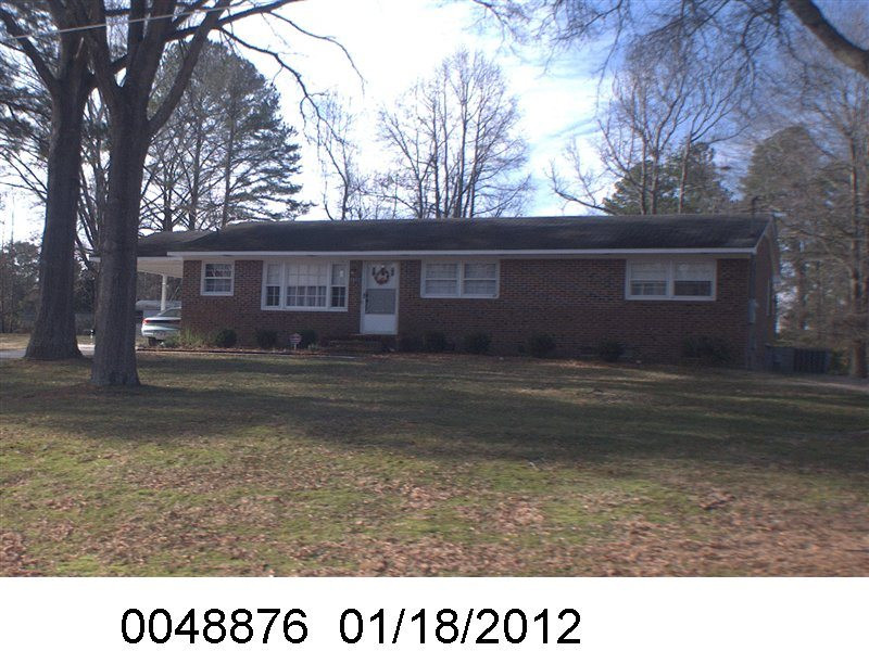 2602 Friendly Trail Raleigh, NC 27610 - Photo 1 of 2 a black and white photo of a house with a yard