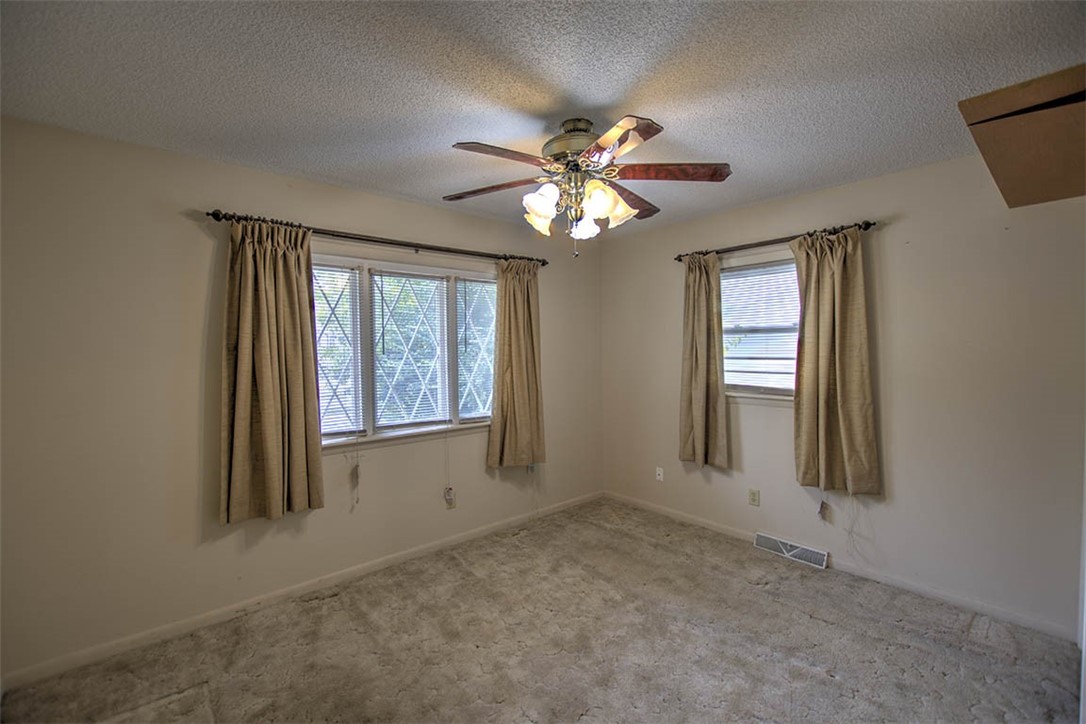 2273 North Fairview Avenue Decatur, IL 62526 - Photo 10 of 24 an empty room with windows and chandelier fan