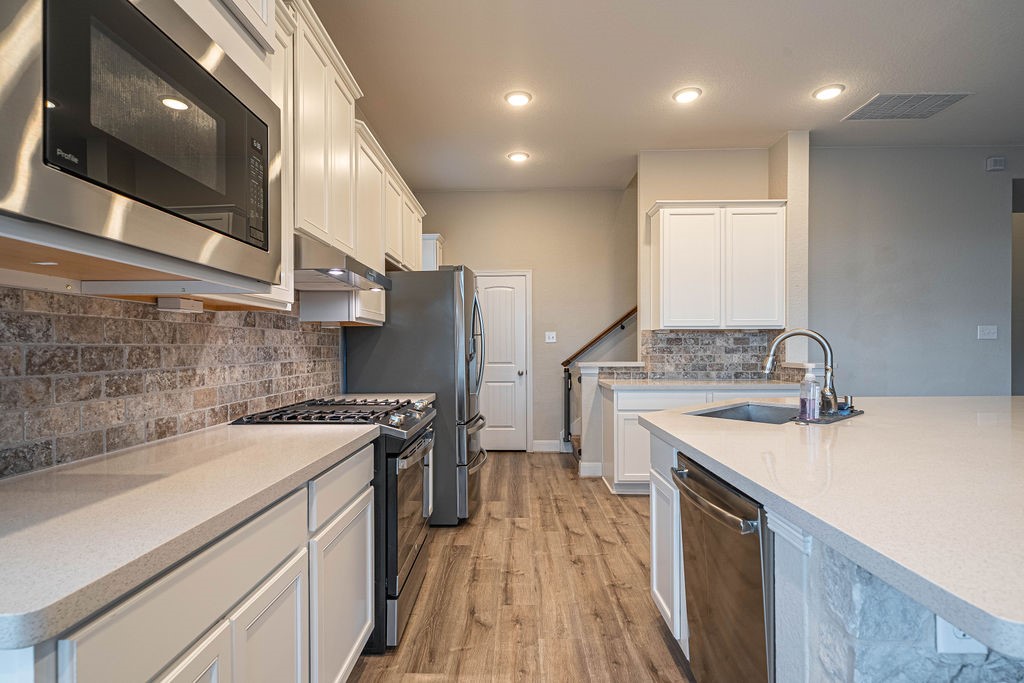 830 Rench New Braunfels, TX 78130 - Photo 10 of 50 a kitchen with a sink stove and refrigerator