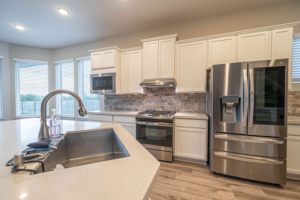830 Rench New Braunfels, TX 78130 - Photo 11 of 50 a kitchen with a refrigerator sink and cabinets