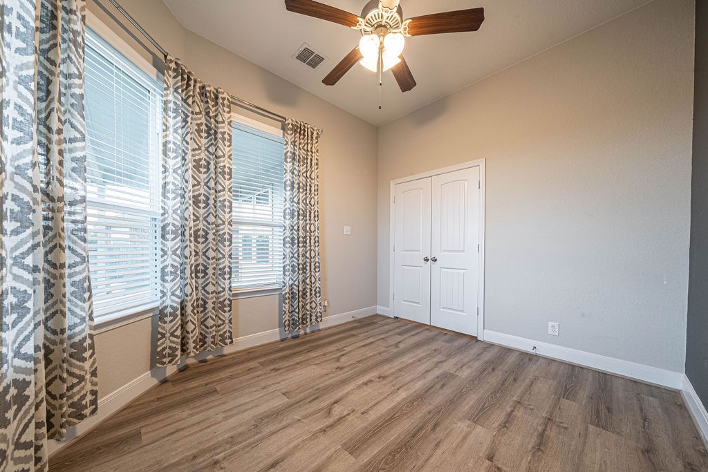 830 Rench New Braunfels, TX 78130 - Photo 15 of 50 wooden floor in an empty room with a window