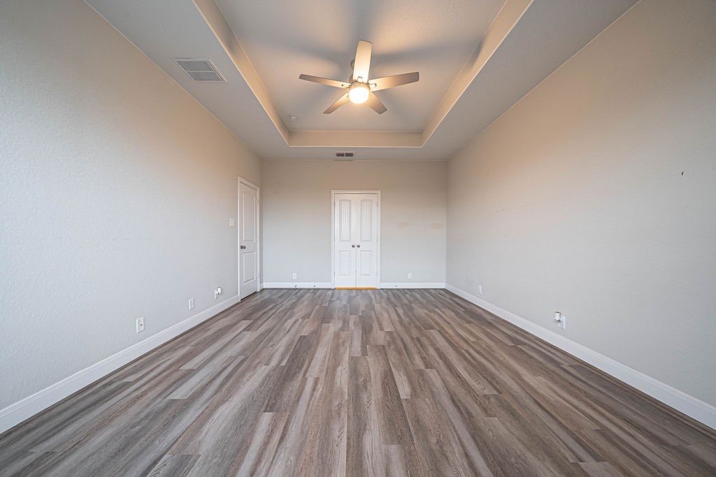 830 Rench New Braunfels, TX 78130 - Photo 20 of 50 wooden floor in an empty room with a window