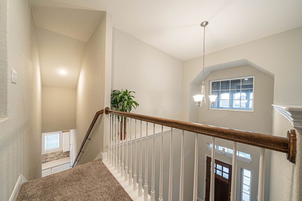 830 Rench New Braunfels, TX 78130 - Photo 27 of 50 a view of staircase with railing and a chandelier