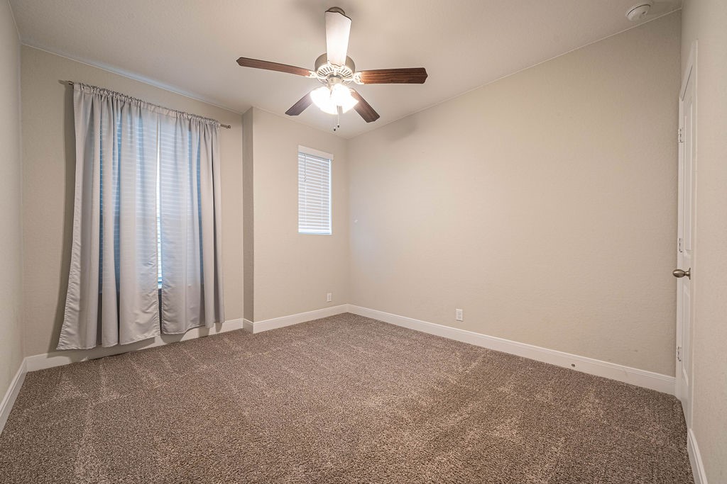 830 Rench New Braunfels, TX 78130 - Photo 29 of 50 an empty room with a chandelier fan and windows