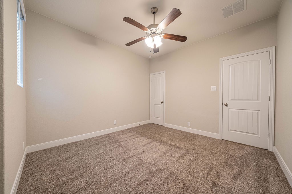 830 Rench New Braunfels, TX 78130 - Photo 30 of 50 an empty room with closet and a ceiling fan