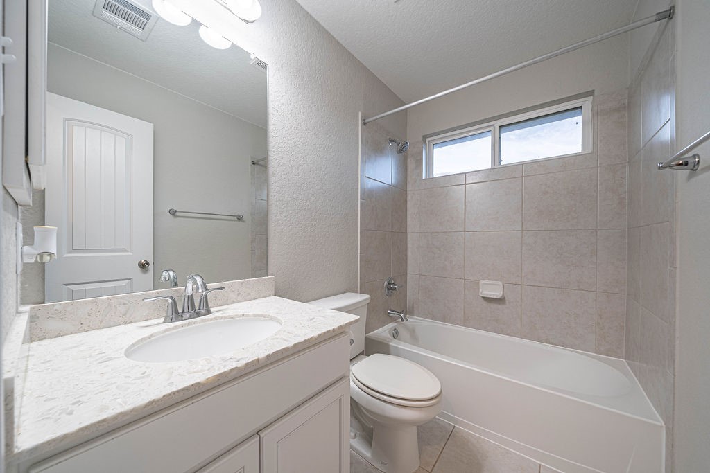 830 Rench New Braunfels, TX 78130 - Photo 31 of 50 a bathroom with a granite countertop sink a toilet and bathtub