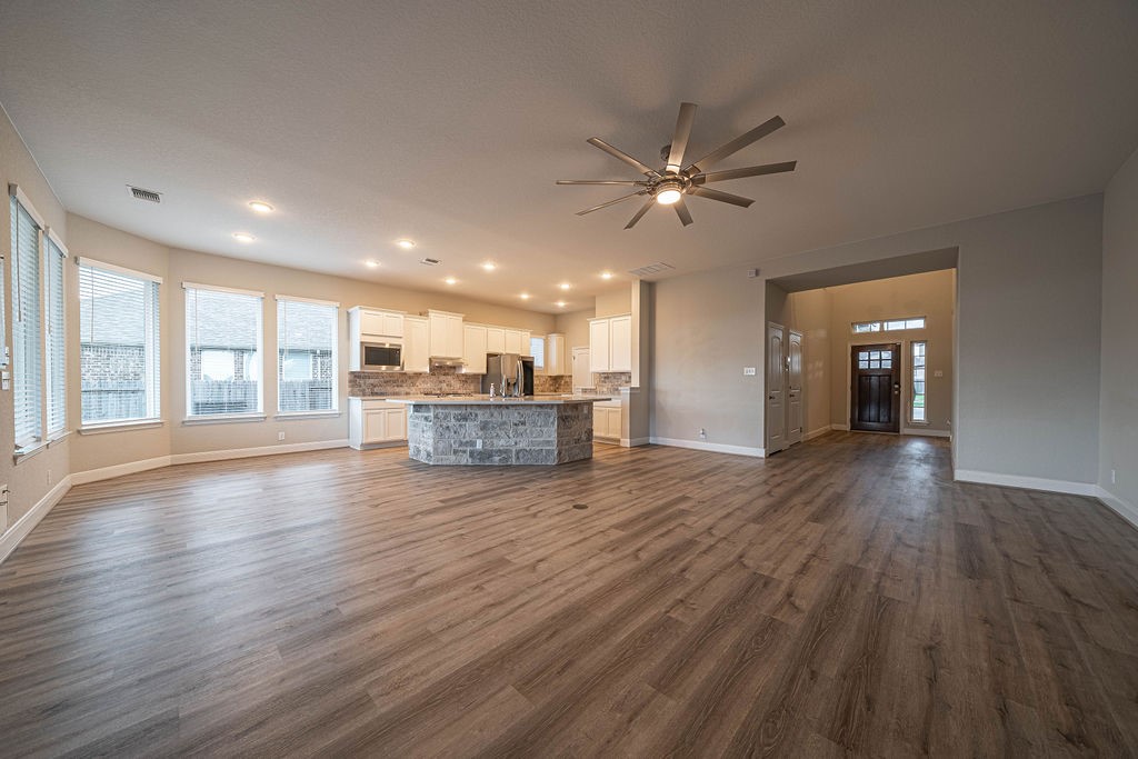 830 Rench New Braunfels, TX 78130 - Photo 50 of 50 a view of a livingroom with wooden floor and a ceiling fan