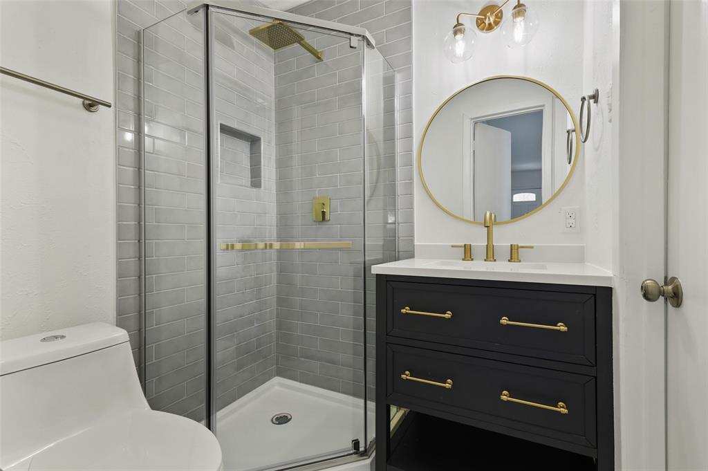 3126 Jubilee Trail Dallas, TX 75229 - Photo 13 of 38 a bathroom with a toilet a sink and mirror