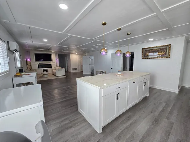 a large white kitchen with lots of counter space a sink and appliances