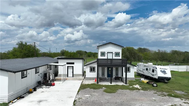 a view of house with yard and entertaining space