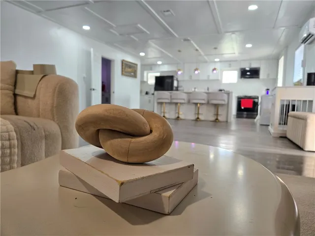 a living room with furniture and kitchen view