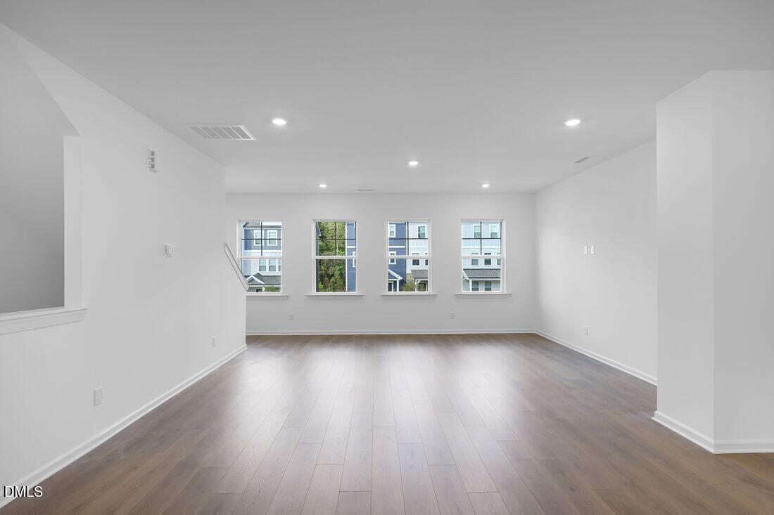430 Rowe Way Knightdale, NC 27545 - Photo 5 of 51 a view of an empty room with wooden floor and a window