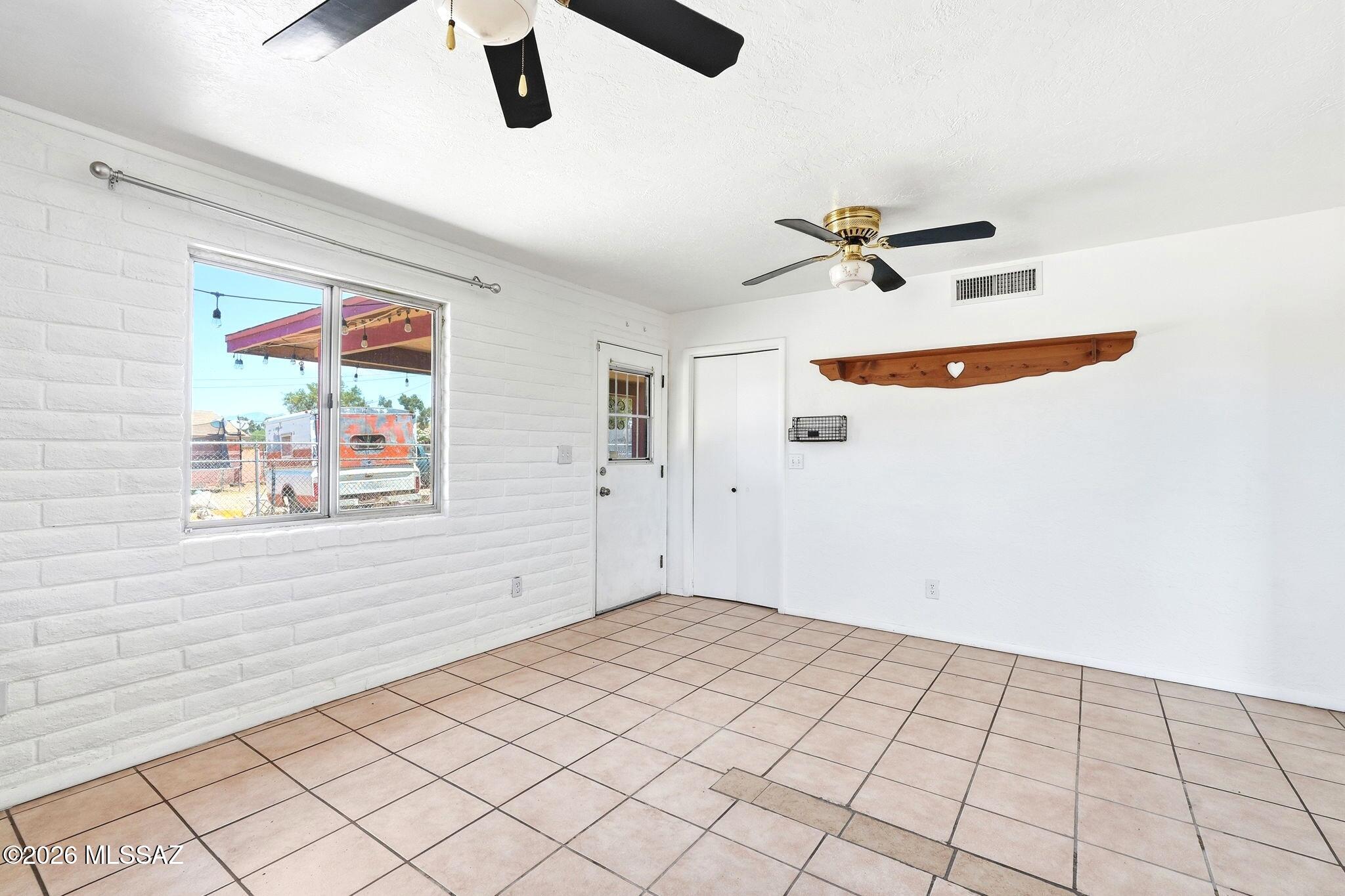5125 South Missiondale Road Tucson, AZ 85706 - Photo 10 of 32 an empty room with windows and ceiling fan