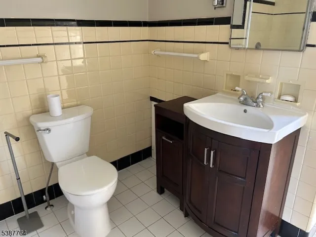 a bathroom with a sink toilet and a mirror