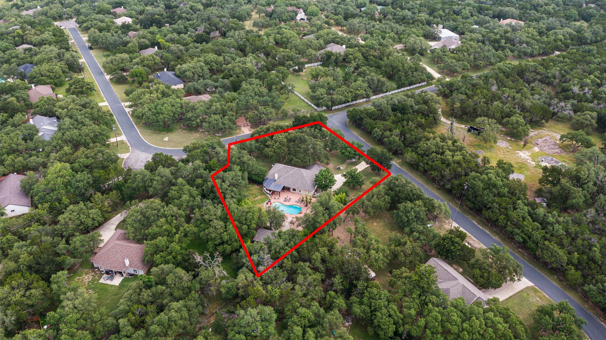 223 East Ridgewood Road Georgetown, TX 78633 - Photo 38 of 40 An aerial perspective reveals a secluded residence surrounded by lush woodlands, complete with a private swimming pool