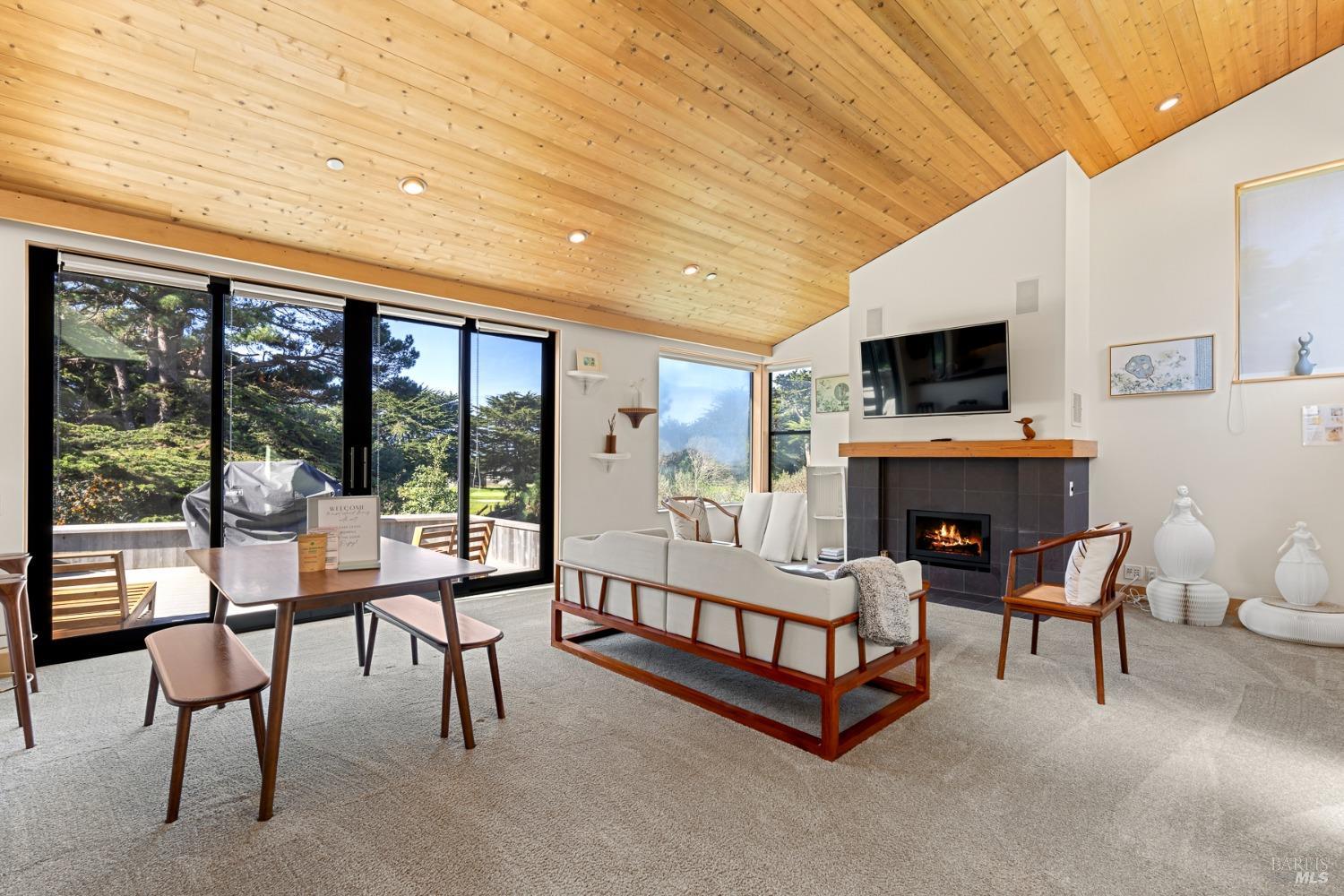 a living room with fireplace furniture and a flat screen tv