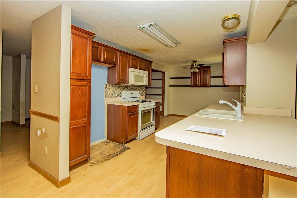 31 Hones Road Export, PA 15632 - Photo 10 of 22 a kitchen with stainless steel appliances granite countertop a sink a stove and a refrigerator