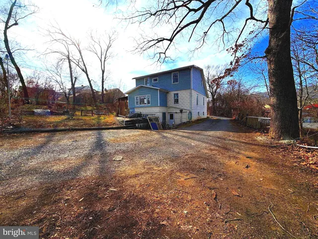 a view of a car park in front of a house