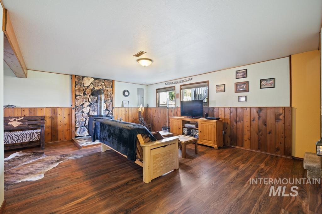 3828 15th Street Lewiston, ID 83501 - Photo 20 of 34 Living area with wainscoting, wood walls, and wood finished floors