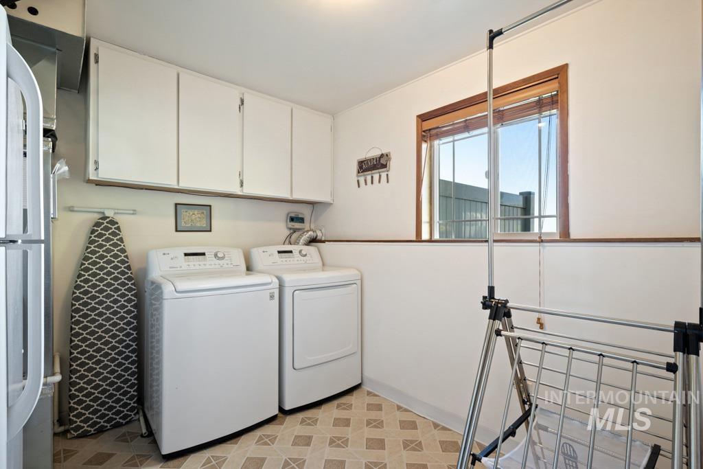 3828 15th Street Lewiston, ID 83501 - Photo 23 of 34 Laundry area with light flooring, washer and dryer, and cabinet space