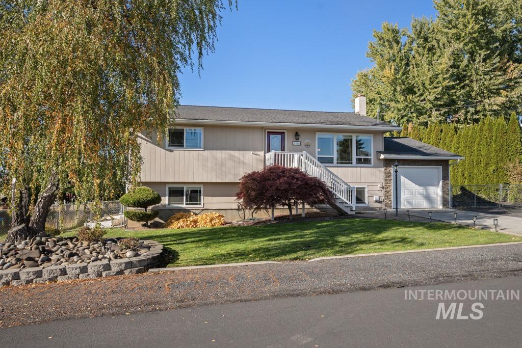 3828 15th Street Lewiston, ID 83501 - Photo 25 of 34 View of front of house featuring a garage, a chimney, and driveway