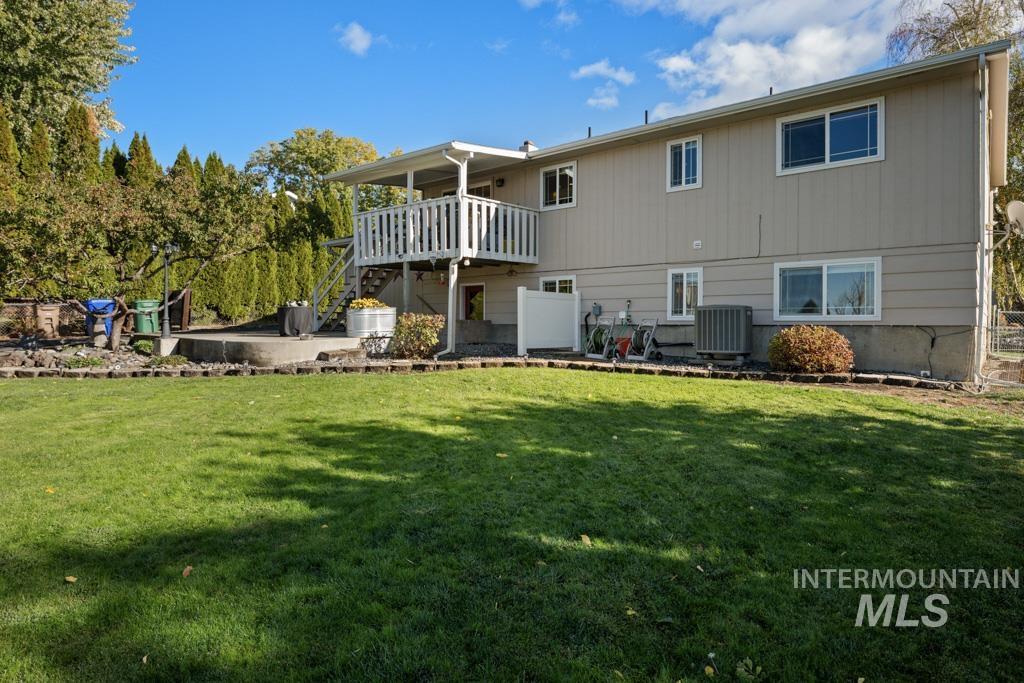 3828 15th Street Lewiston, ID 83501 - Photo 31 of 34 Back of property featuring a lawn, a patio area, and stairway