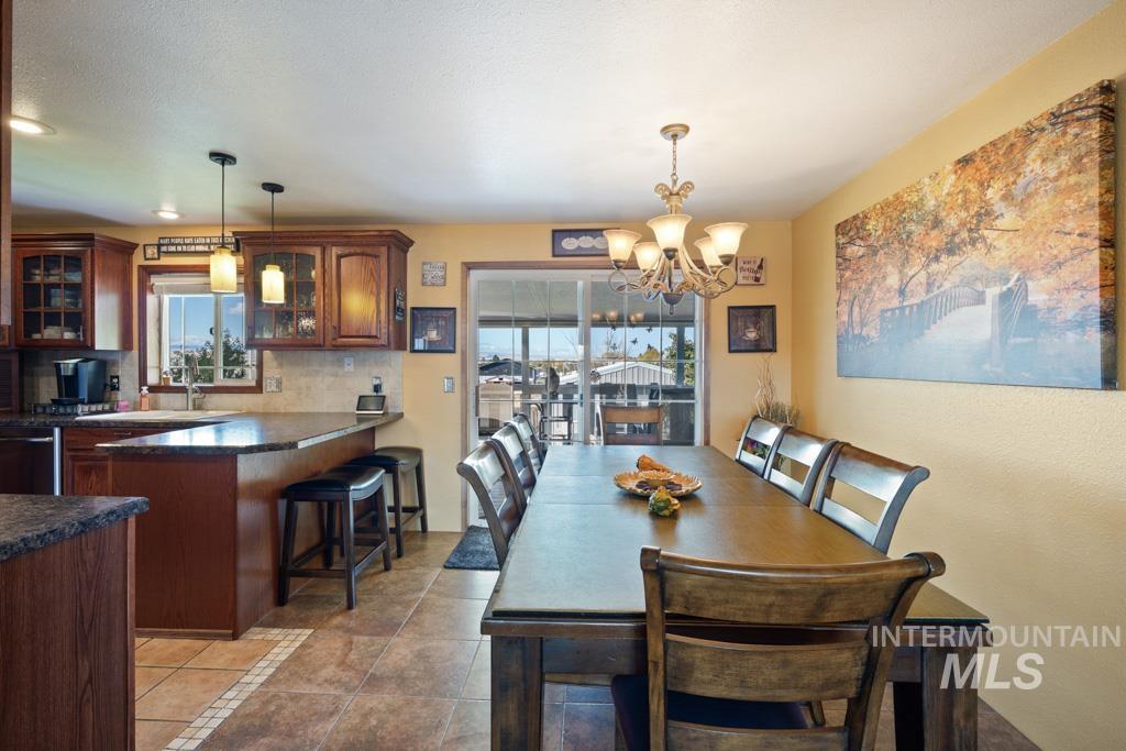 3828 15th Street Lewiston, ID 83501 - Photo 7 of 34 Dining space with a chandelier and dark tile patterned flooring