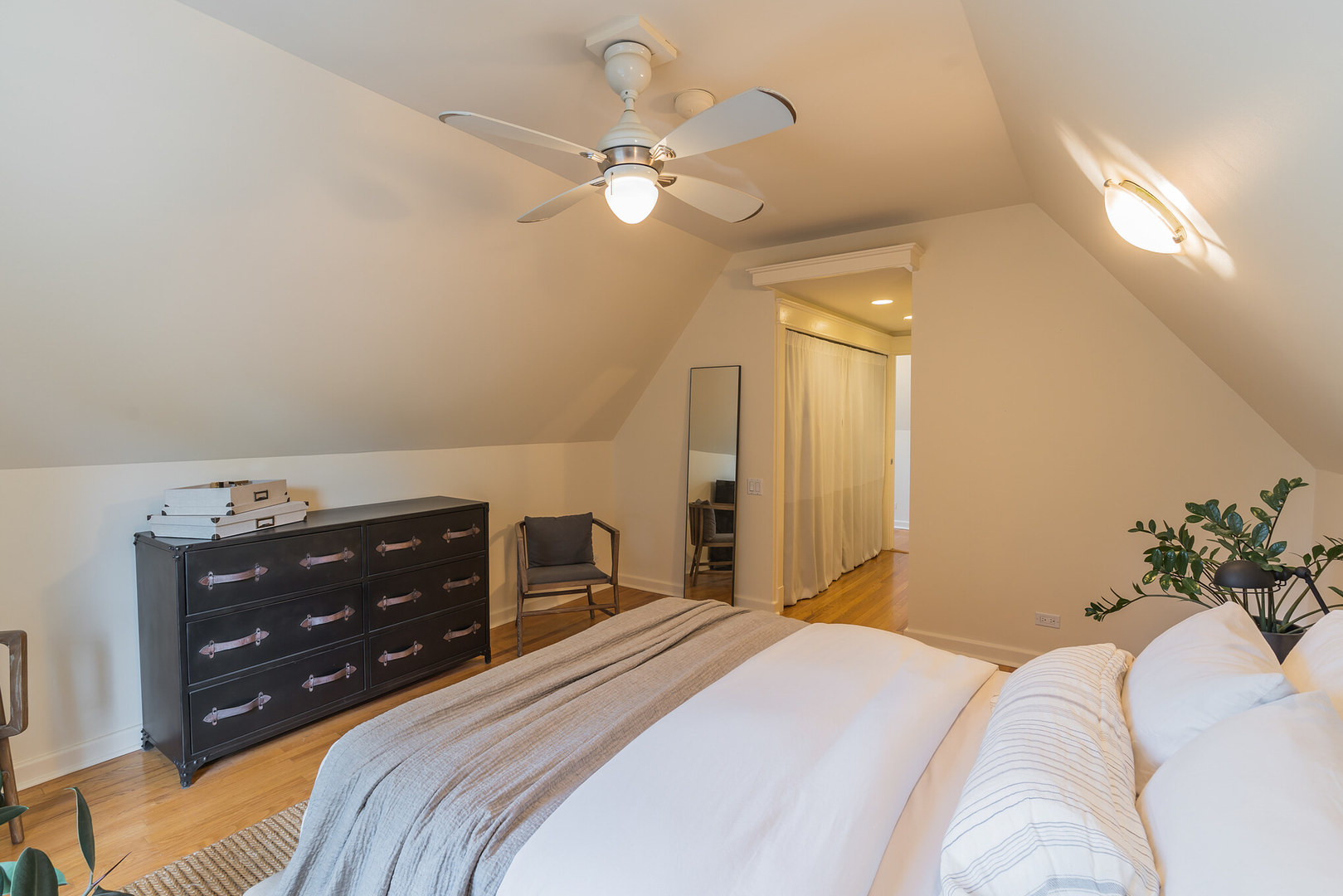 2729 North Racine Avenue, Unit N Chicago, IL 60614 - Photo 14 of 21 a bedroom with a bed and a chandelier