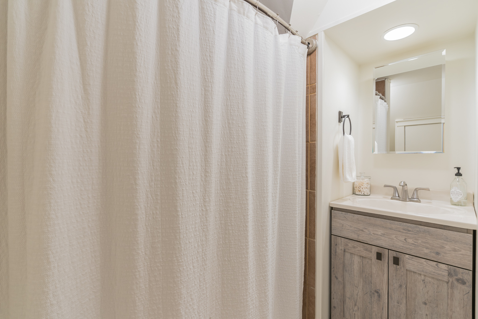 2729 North Racine Avenue, Unit N Chicago, IL 60614 - Photo 15 of 21 a bathroom with a shower curtain and a sink
