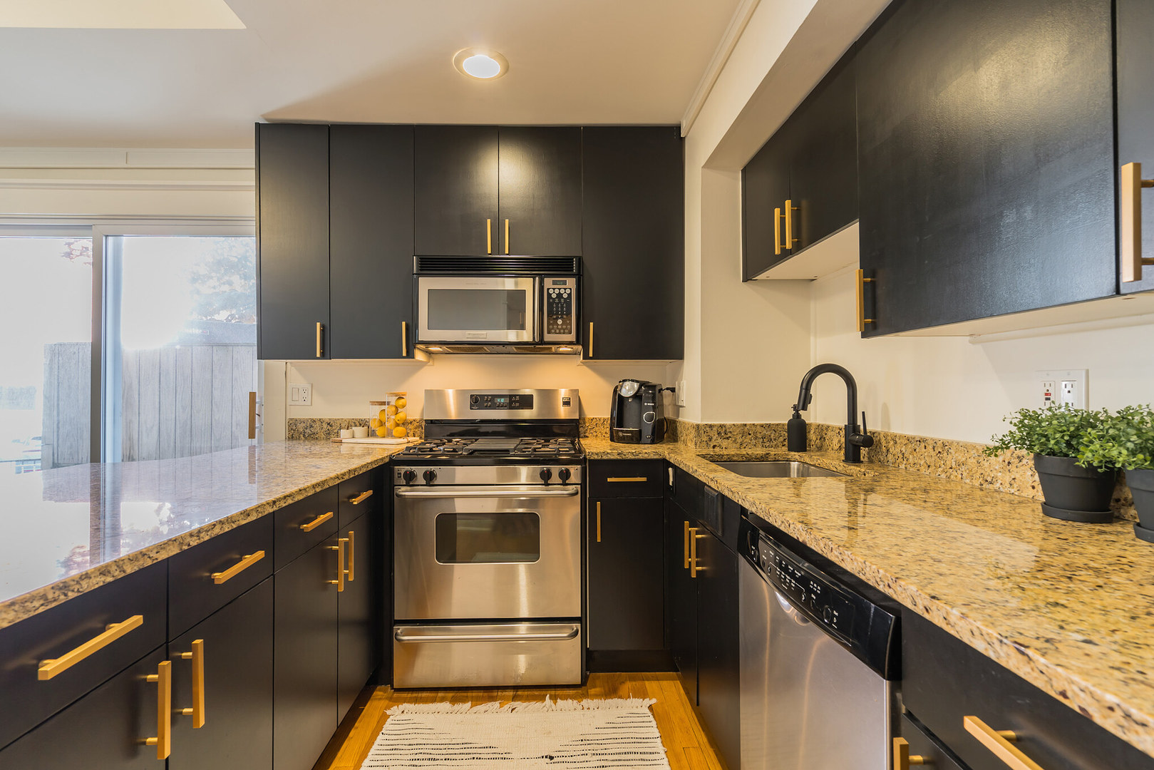 2729 North Racine Avenue, Unit N Chicago, IL 60614 - Photo 8 of 21 a kitchen with stainless steel appliances granite countertop a sink a stove and a refrigerator