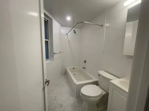 a bathroom with a granite countertop toilet and a shower