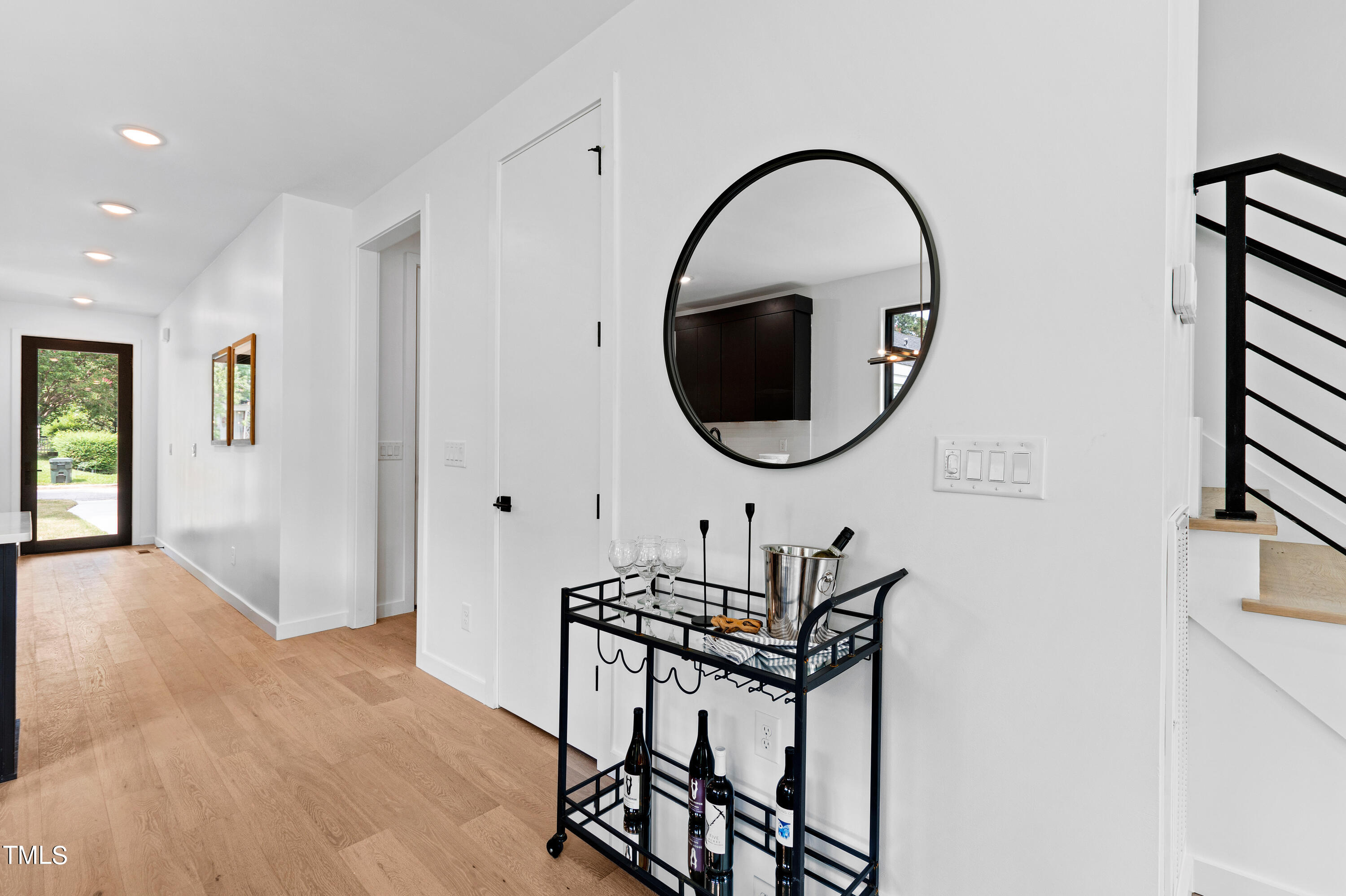 716 Brighton Road, Unit 102 Raleigh, NC 27610 - Photo 16 of 78 a living room with furniture a mirror and a wooden floor
