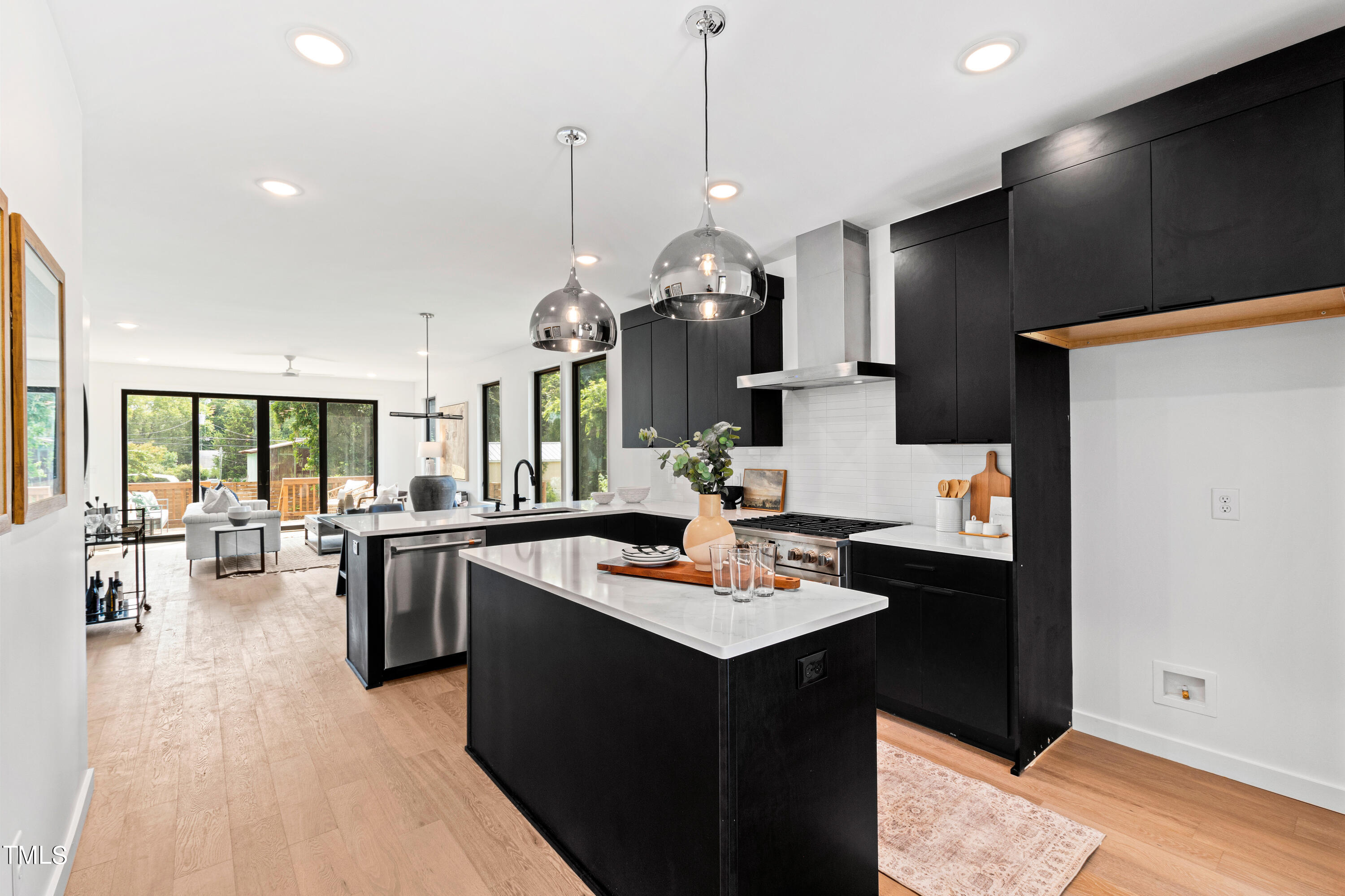 716 Brighton Road, Unit 102 Raleigh, NC 27610 - Photo 21 of 78 a kitchen with a refrigerator a stove a sink dishwasher with a dining table and chairs with wooden floor