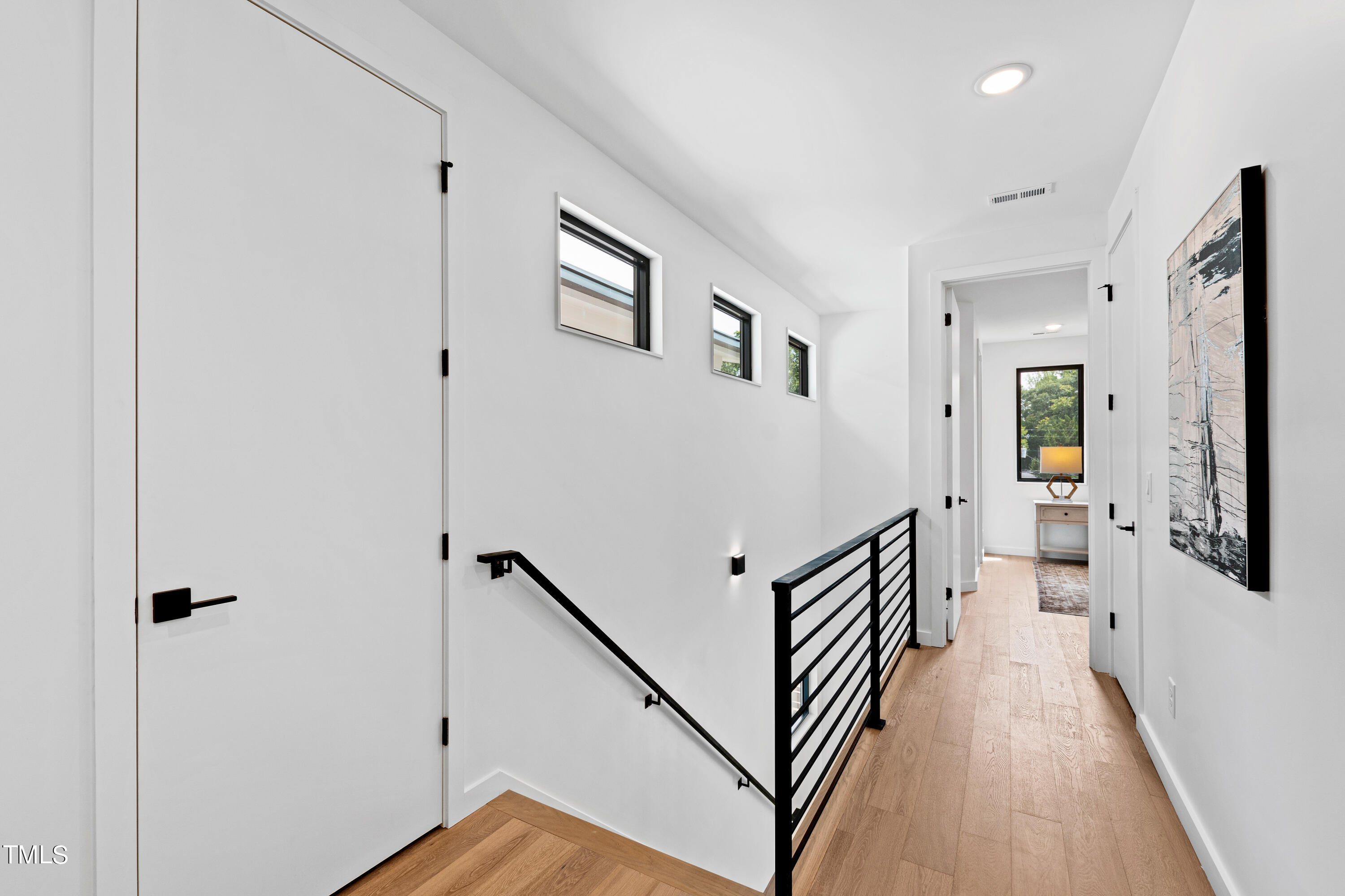 716 Brighton Road, Unit 102 Raleigh, NC 27610 - Photo 36 of 78 a view of a hallway with wooden floor and staircase