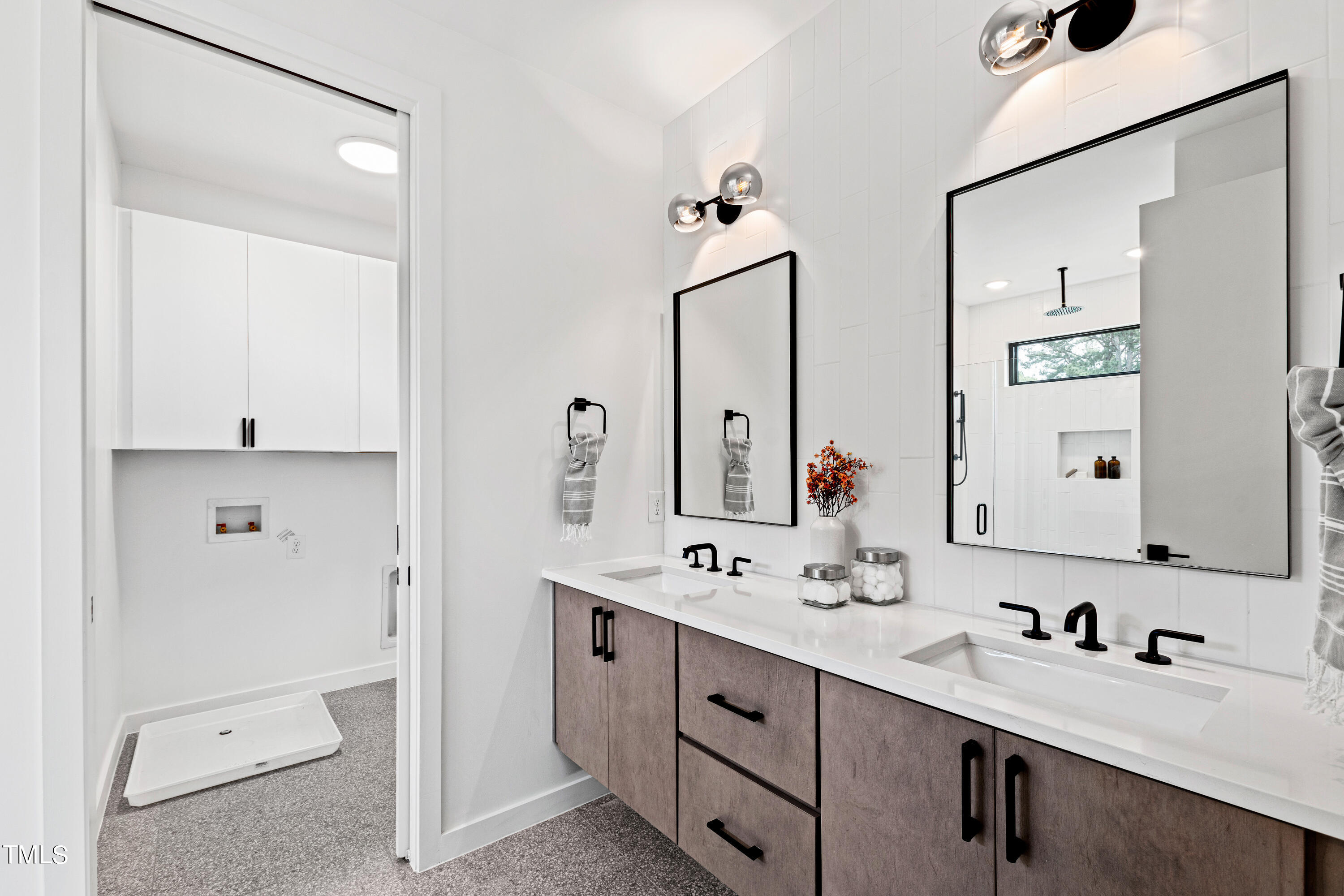 716 Brighton Road, Unit 102 Raleigh, NC 27610 - Photo 42 of 78 a bathroom with a double vanity sink mirror and