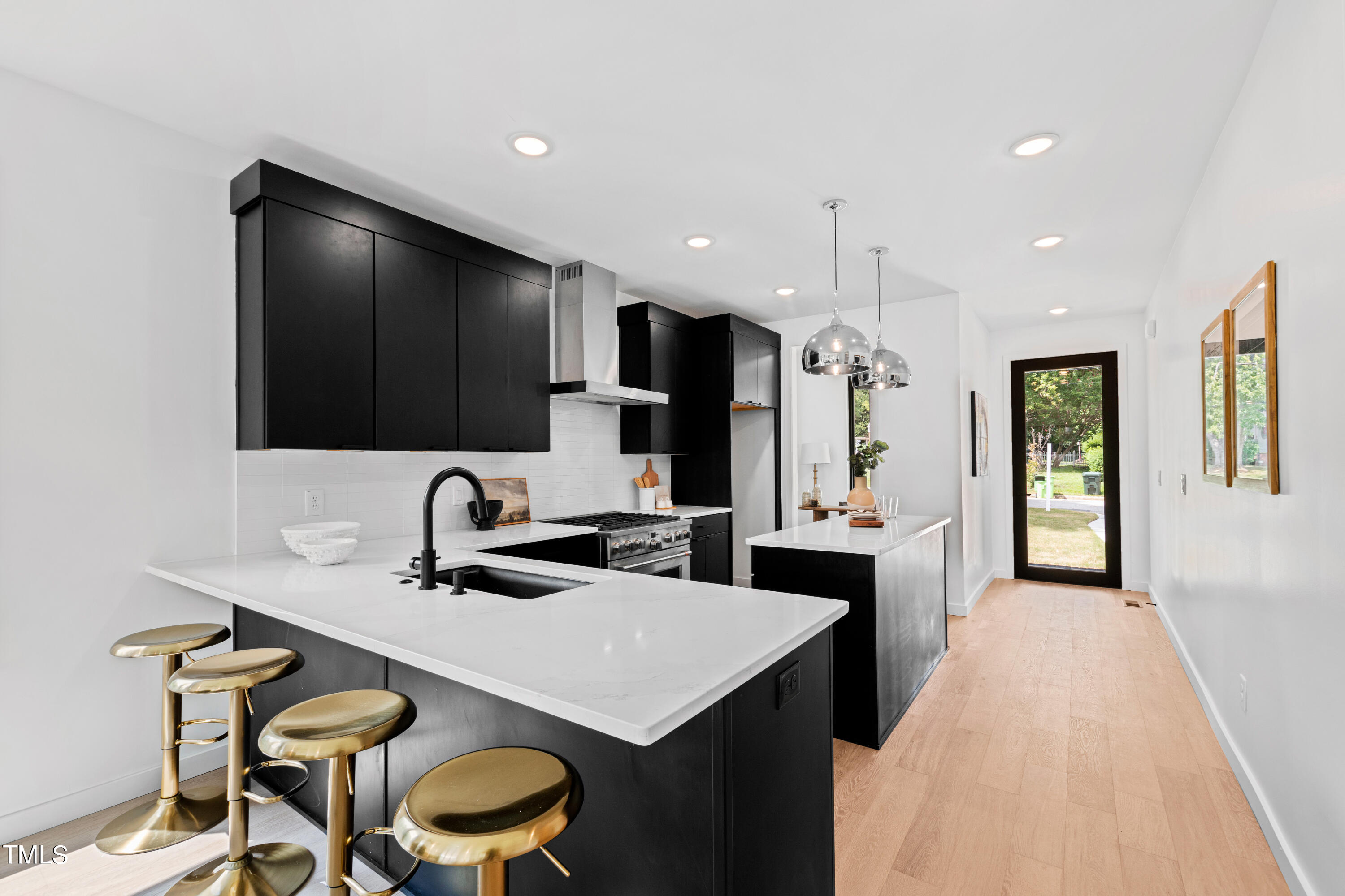 716 Brighton Road, Unit 102 Raleigh, NC 27610 - Photo 5 of 78 a kitchen with stainless steel appliances a sink and a refrigerator