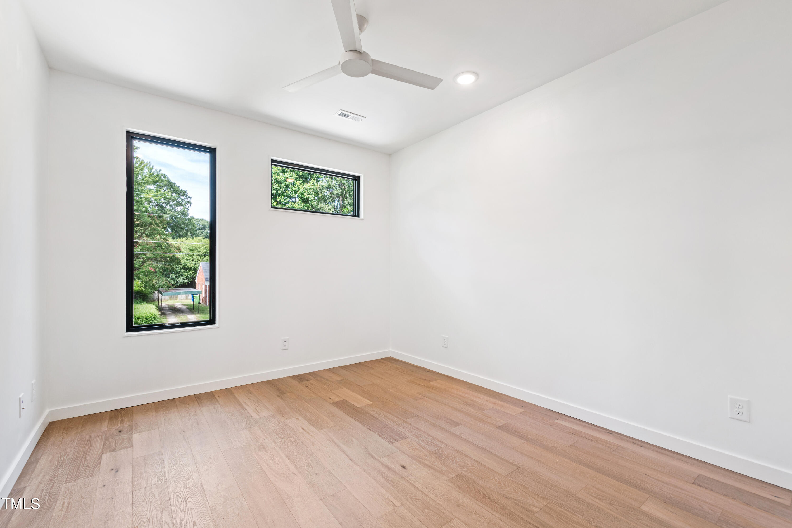 716 Brighton Road, Unit 102 Raleigh, NC 27610 - Photo 55 of 78 an empty room with a window and a ceiling fan