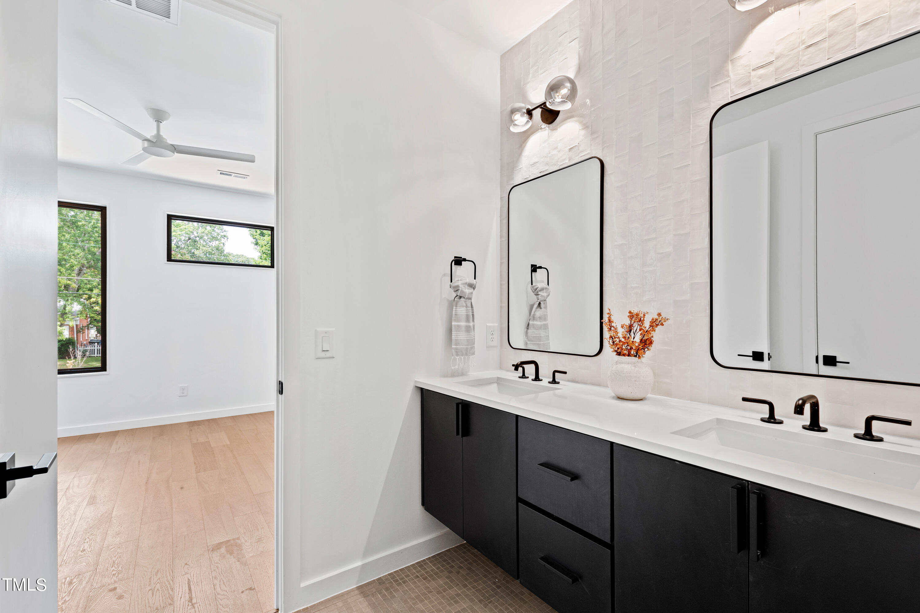 716 Brighton Road, Unit 102 Raleigh, NC 27610 - Photo 60 of 78 a bathroom with a double vanity sink mirror and