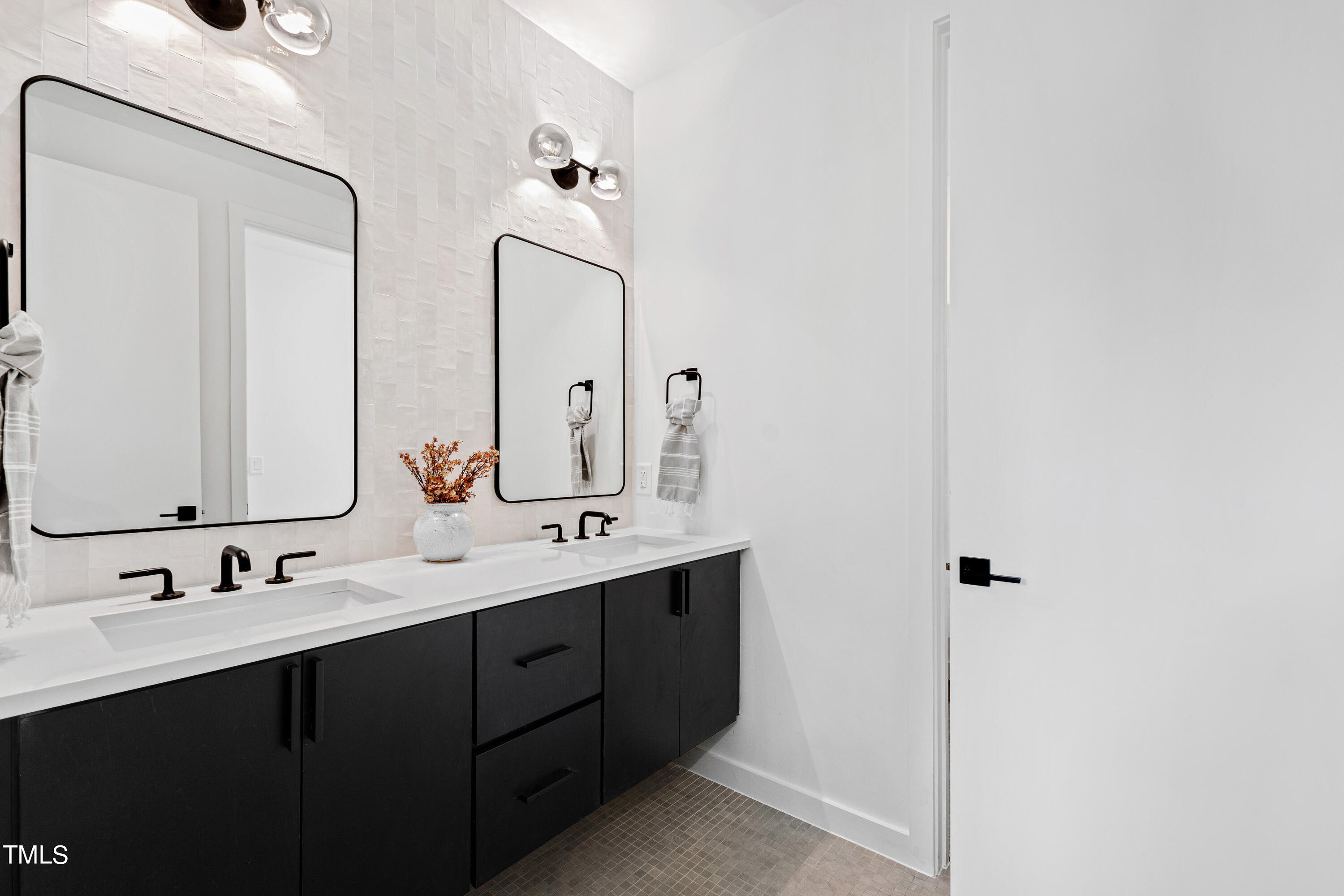716 Brighton Road, Unit 102 Raleigh, NC 27610 - Photo 62 of 78 a bathroom with double vanity and mirrors
