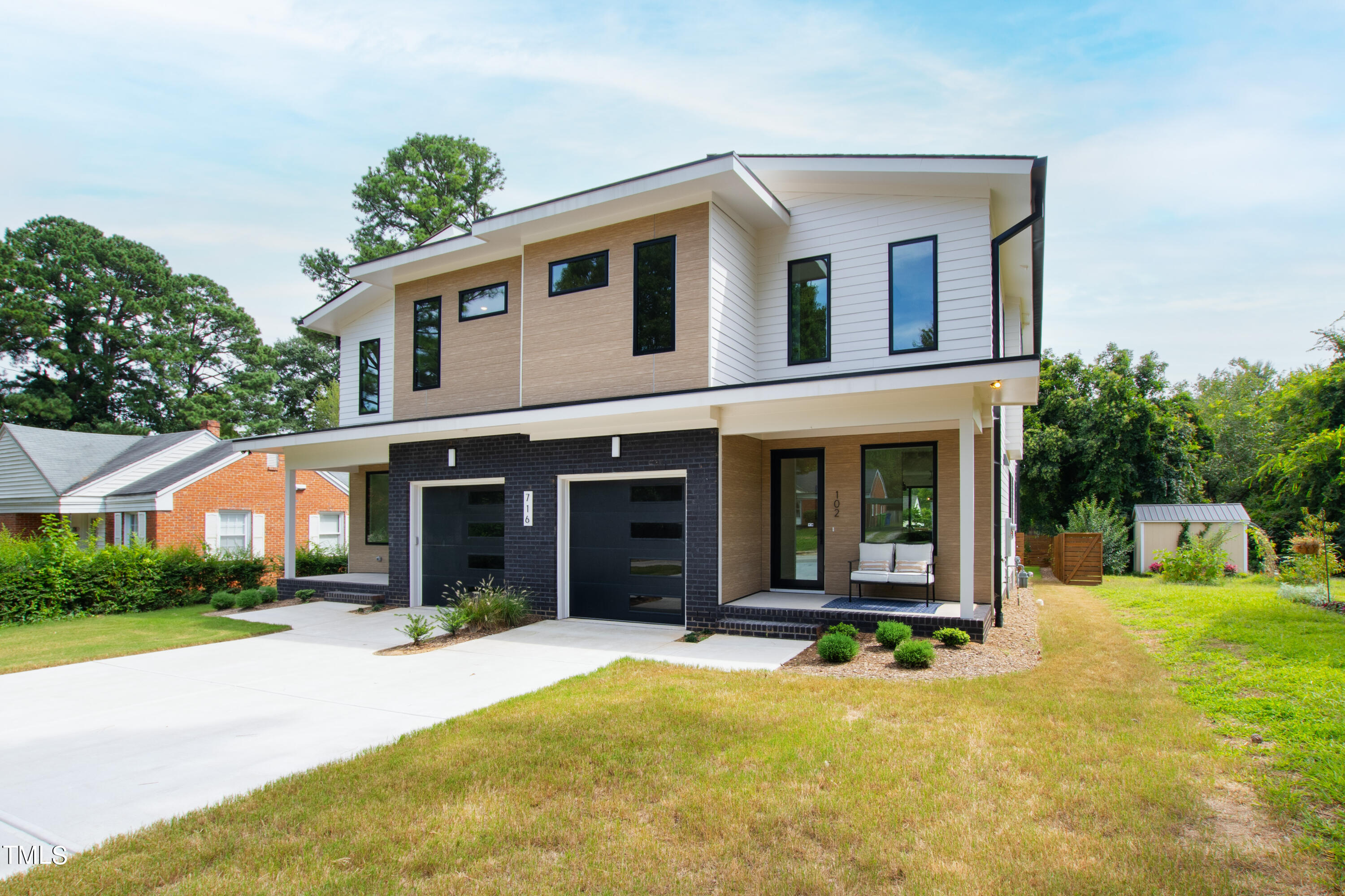 716 Brighton Road, Unit 102 Raleigh, NC 27610 - Photo 77 of 78 a front view of a house with yard and green space