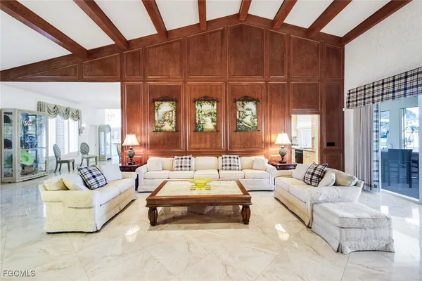 a living room with furniture a wooden floor and a large window