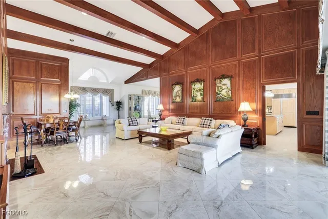 a living room with furniture and large windows