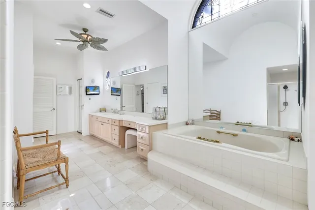 a bathroom with a tub sink and mirror