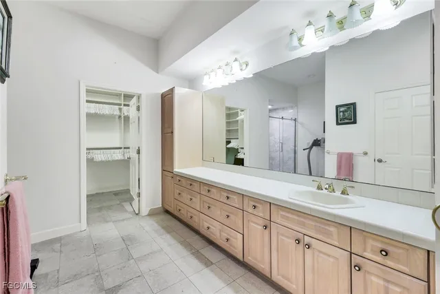 a spacious bathroom with a granite countertop sink a mirror and a