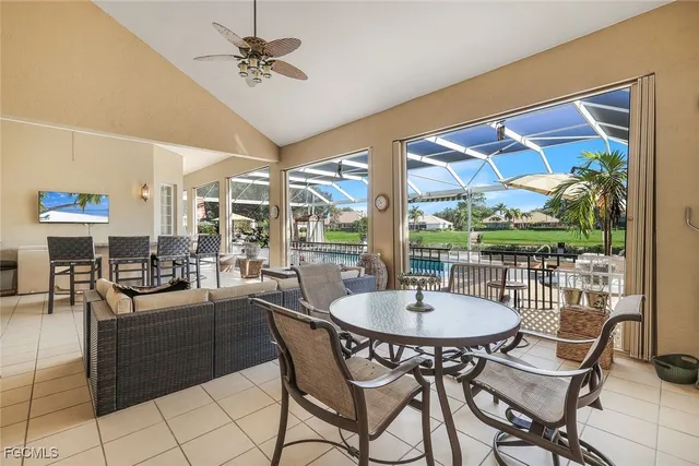 a dining room with furniture a chandelier and wooden floor