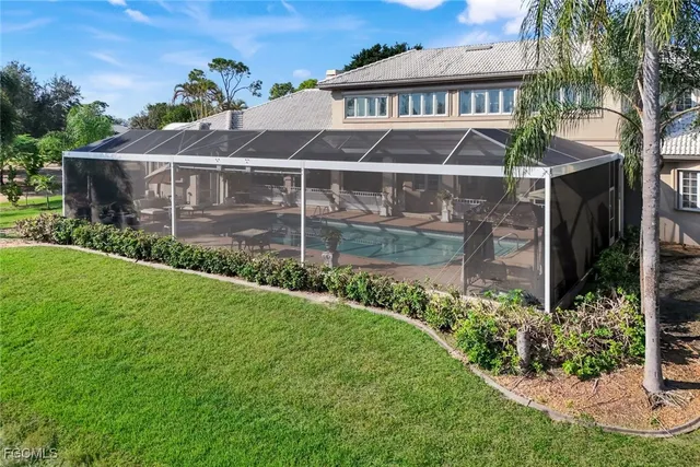 a view of a house with a yard and potted plants