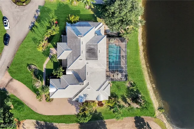 an aerial view of a house with a yard